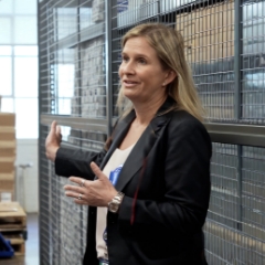 PS Employee in front of pallets and products