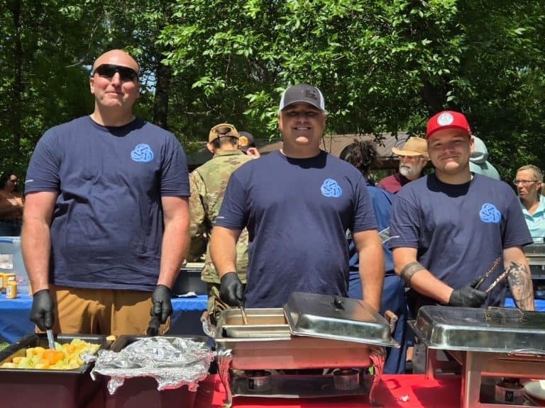 Three men serving food